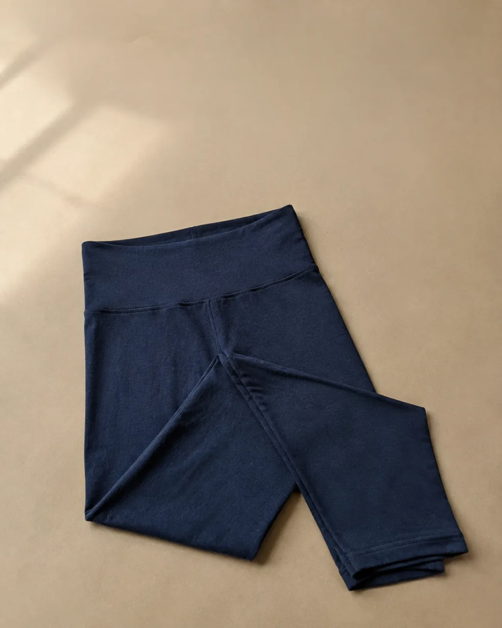 a pair of leggings folded once at the knee and laid flat with a high rise and a full elastic waistband , fabric: Pima cotton and modal knit (modal counted with rayon)